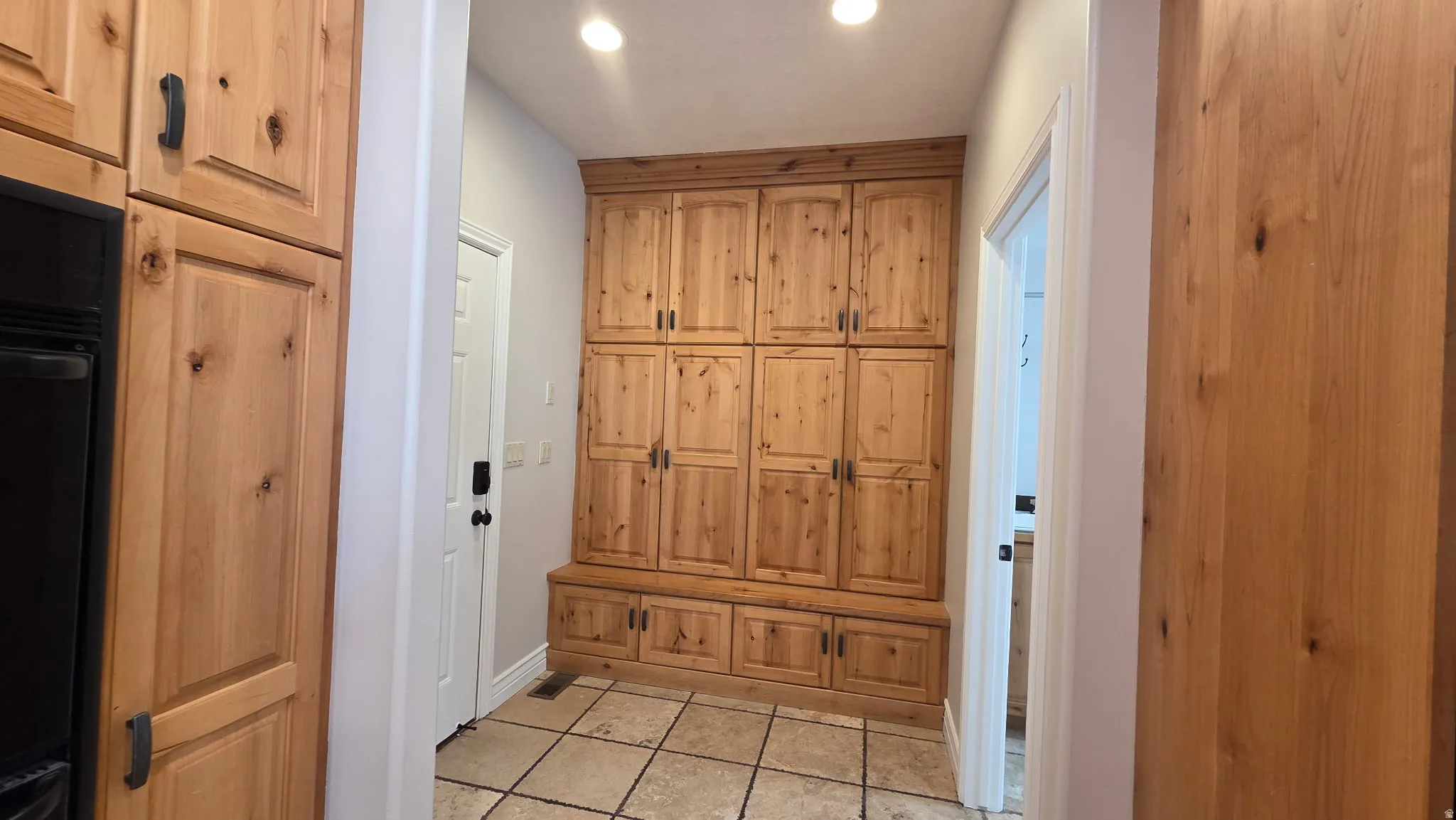 Mudroom with light tile patterned flooring and recessed lighting