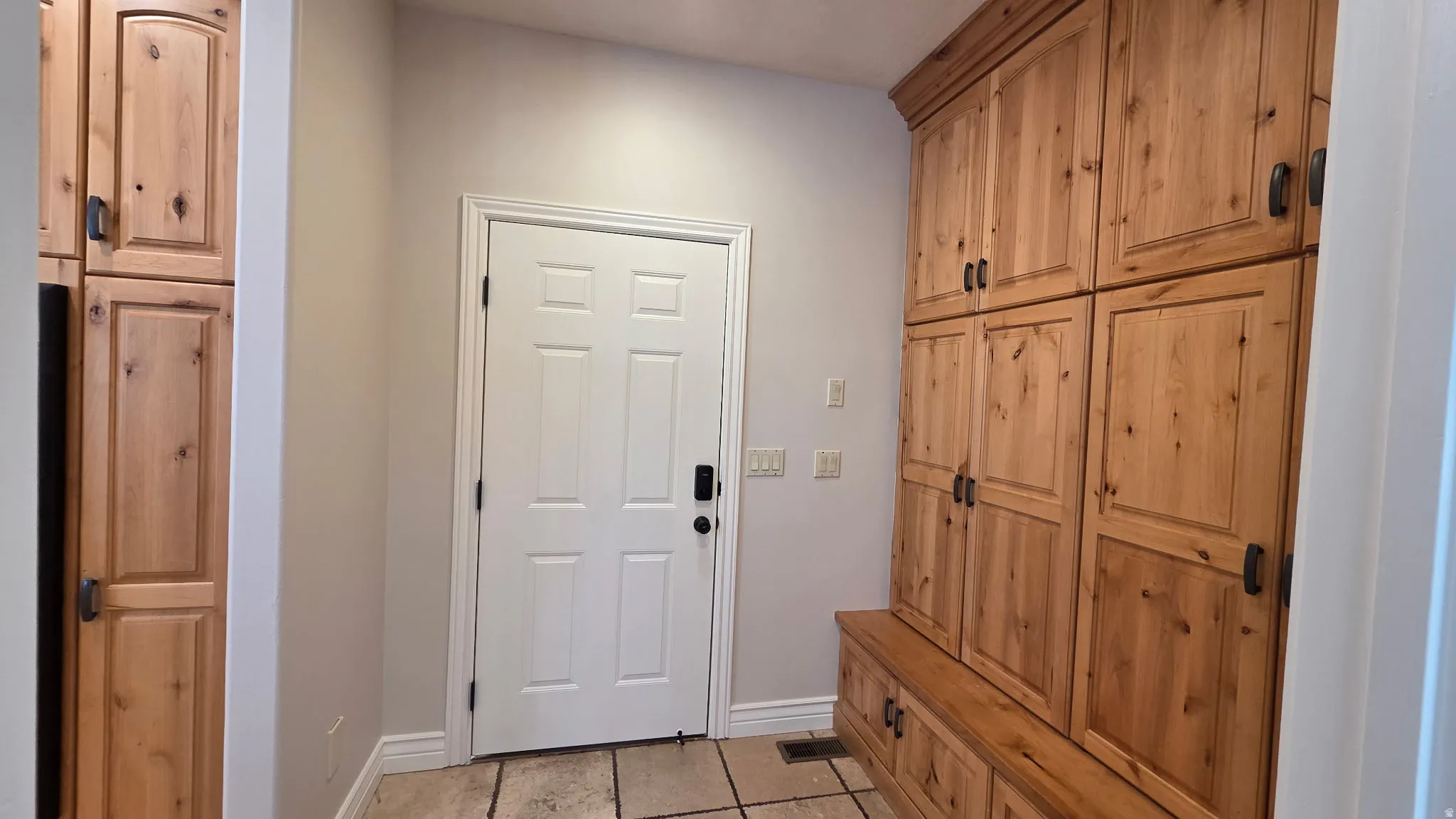 Mudroom featuring light tile patterned floors and baseboards