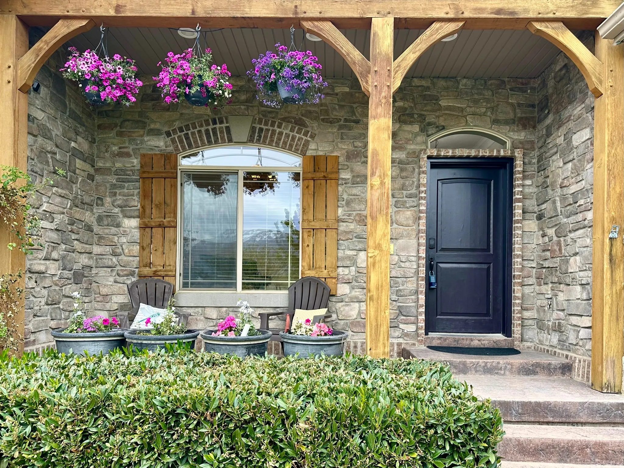 Beautiful covered porch, stone facade with timber frame porch
