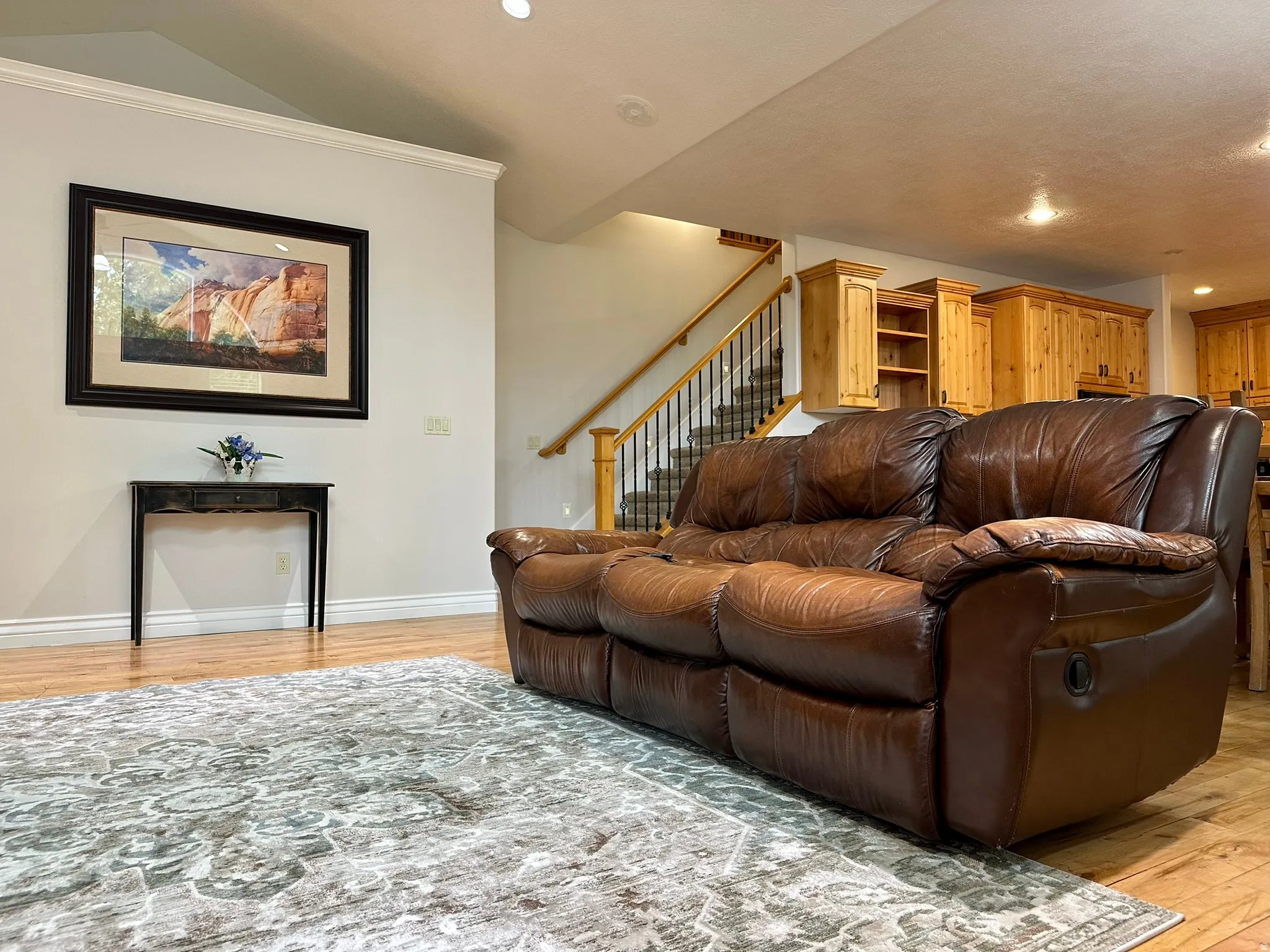 Hardwood flooring complemented by crown molding and recessed lighting