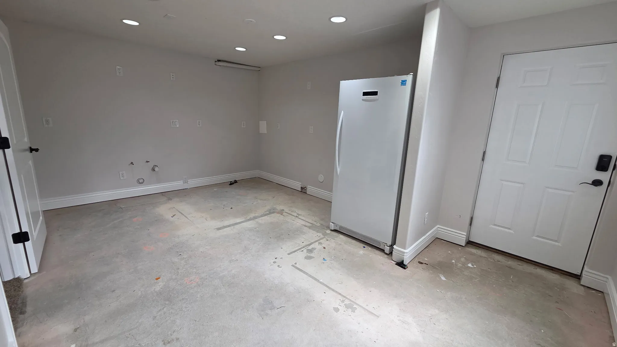 Unfurnished future kitchen with hookups and exterior door to walkup.