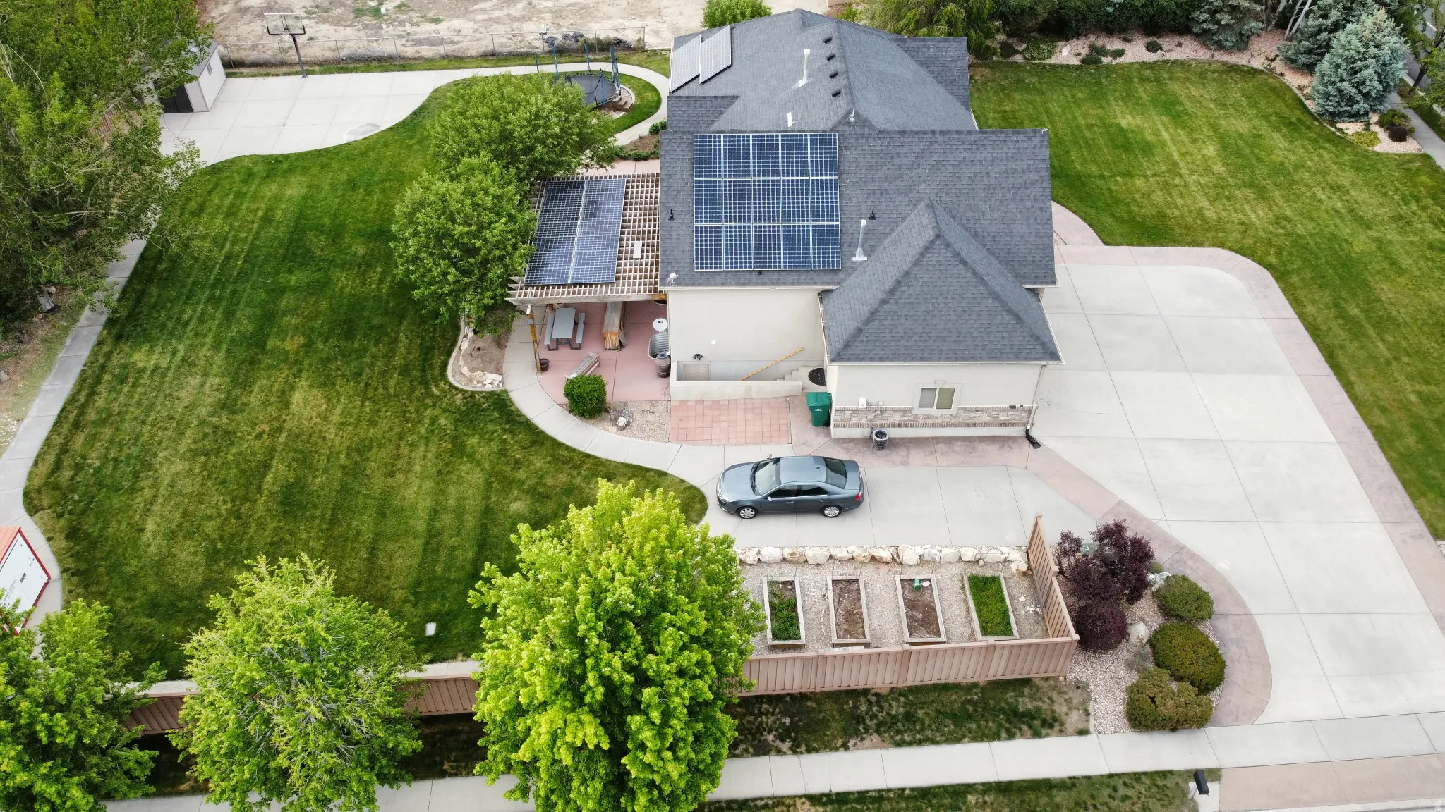 Residence featuring a dark shingle roof with solar panels