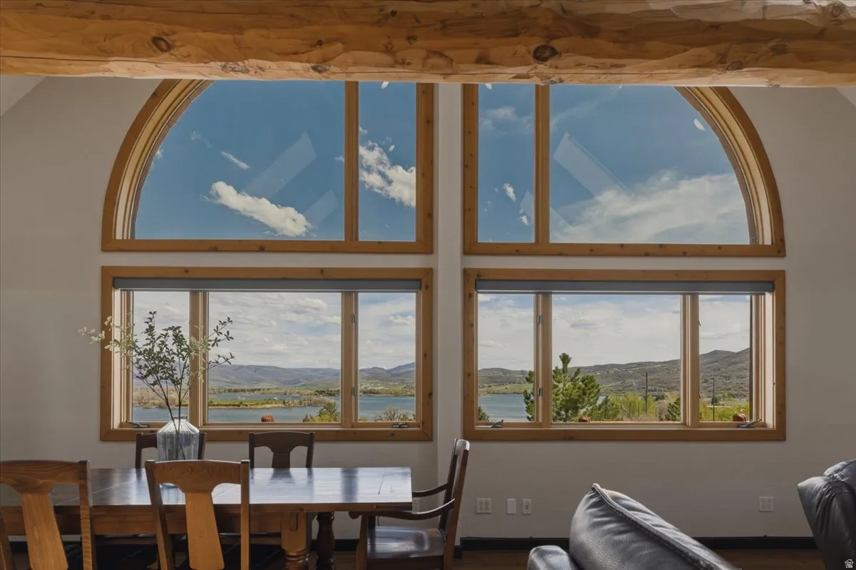 Dining area with a water and mountain view and wood finished floors