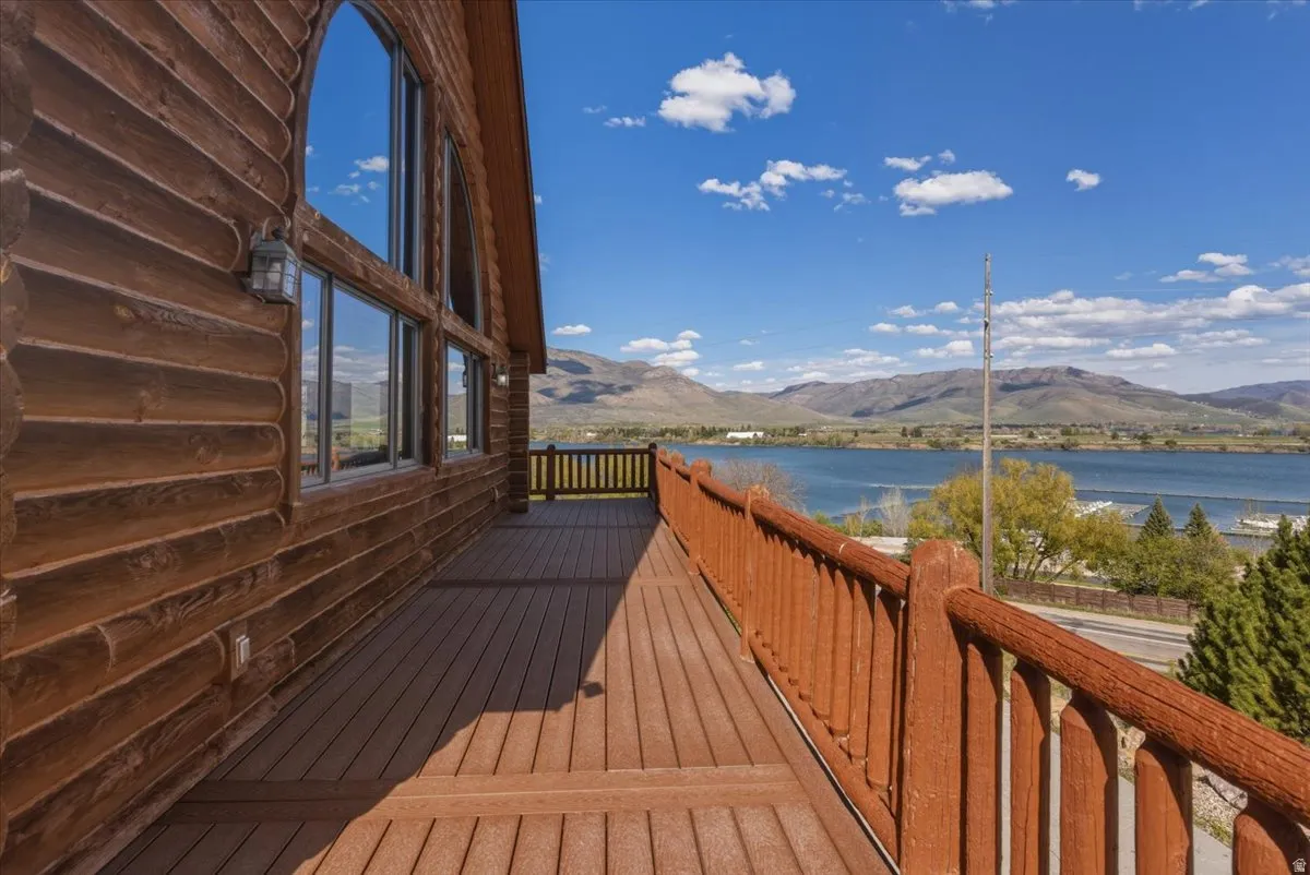 Wooden deck featuring a water and mountain view