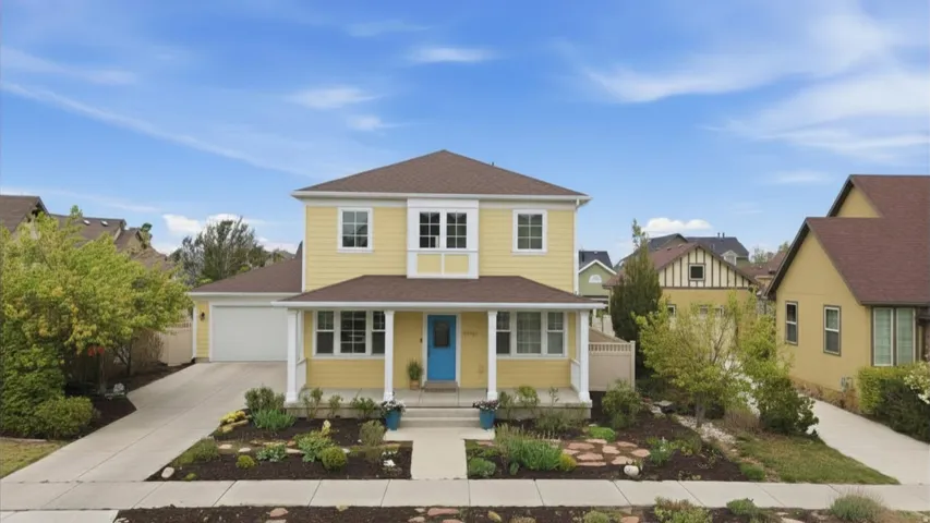 View of front facade featuring covered porch, driveway, an attached garage, and a shingled roof