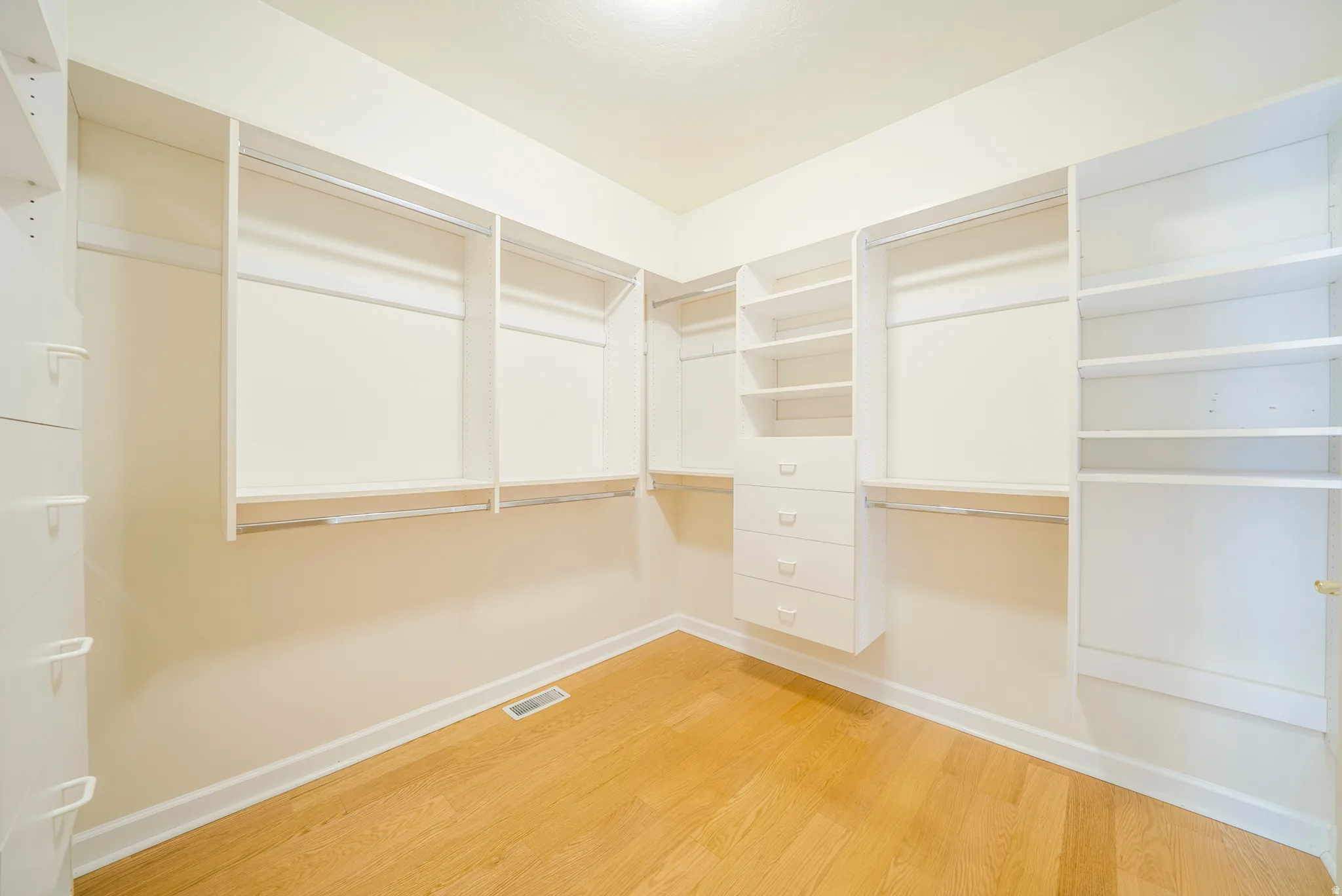 Walk in closet featuring light wood finished floors