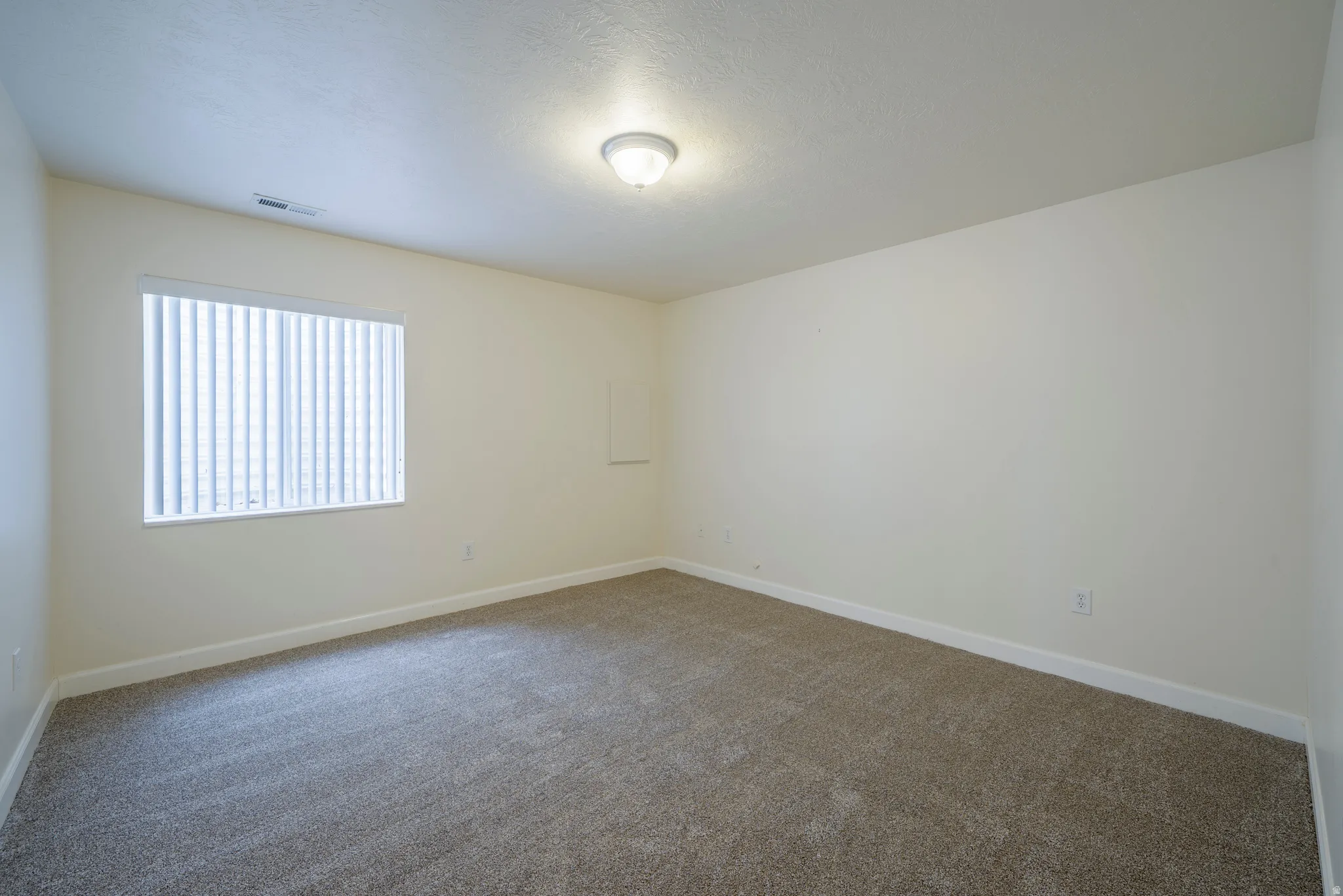 Unfurnished room featuring baseboards and carpet