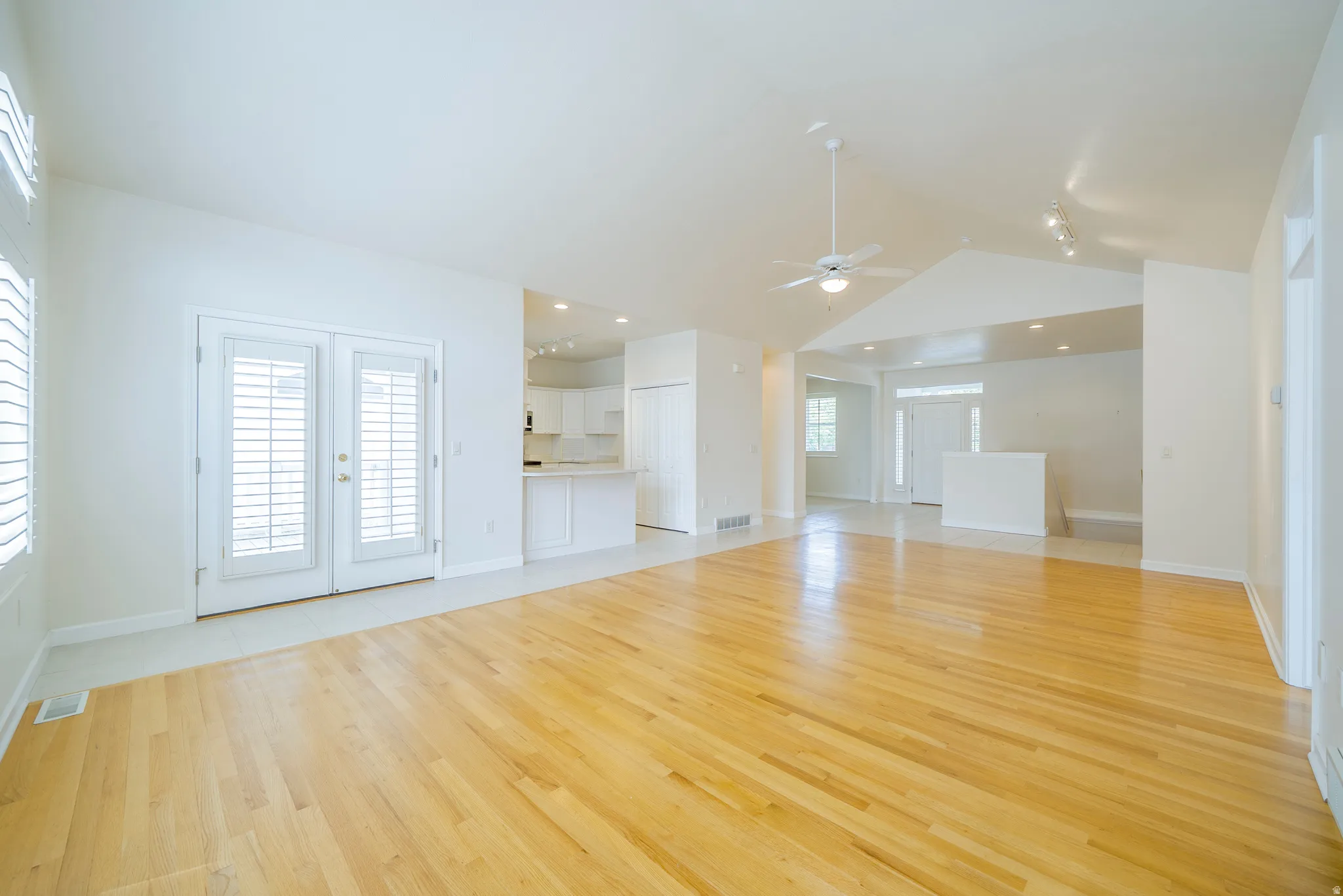 Unfurnished living room with a ceiling fan, light wood-type flooring, and recessed lighting
