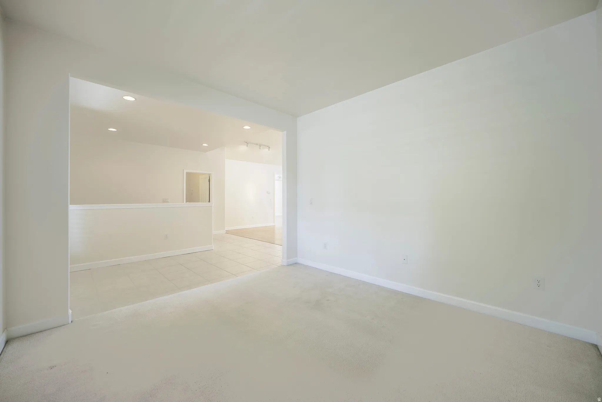 Unfurnished room featuring light colored carpet and recessed lighting