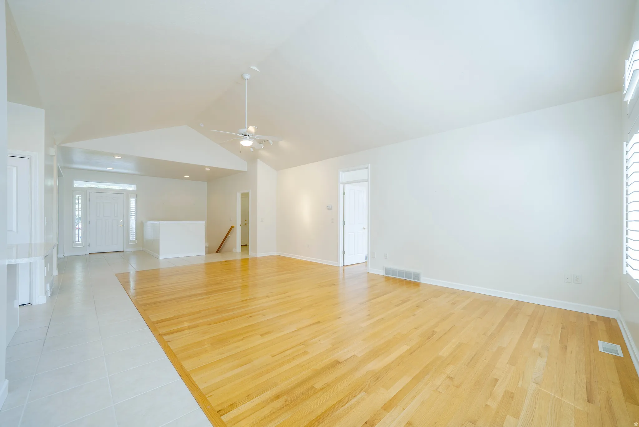 Empty room featuring light wood-style flooring, a ceiling fan, and recessed lighting