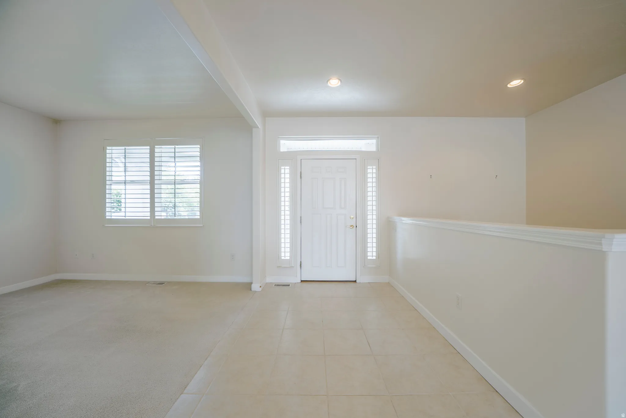 Entrance foyer with recessed lighting and light tile patterned floors