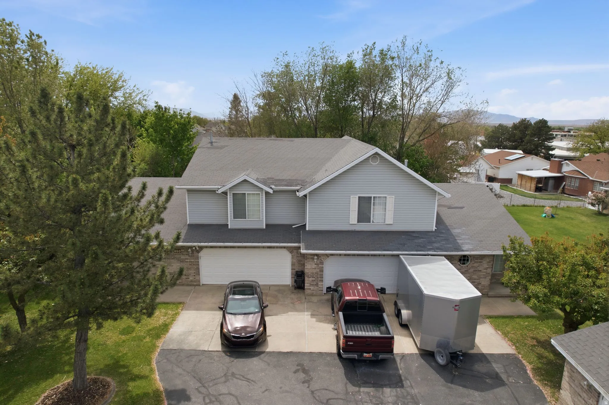 Traditional-style home with a garage, driveway, and brick siding