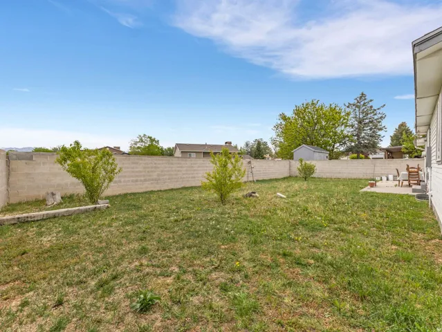 Fenced backyard with a patio area