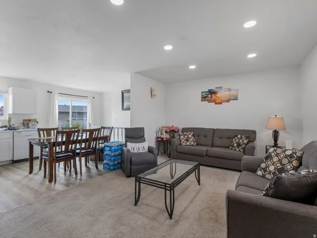 Living area with recessed lighting and light wood-type flooring