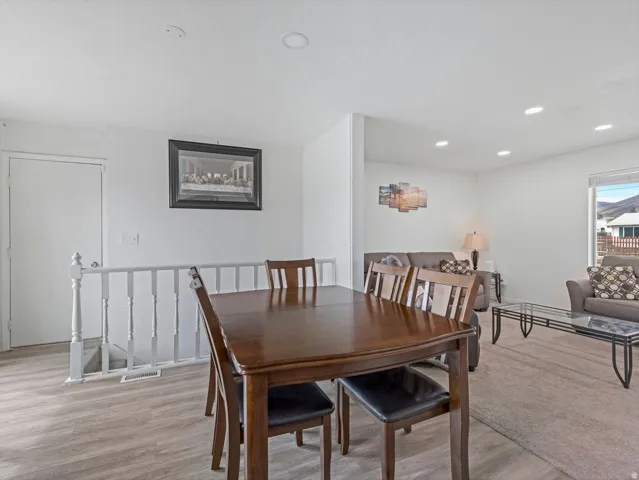 Dining room featuring light wood finished floors and recessed lighting