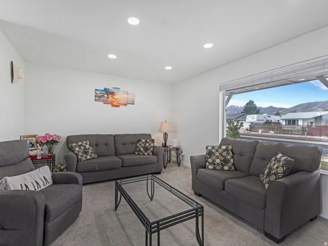 Living area featuring light colored carpet and recessed lighting