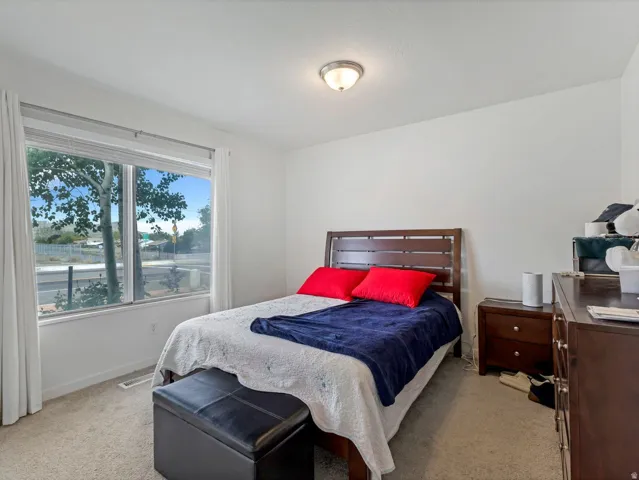 Bedroom with light colored carpet