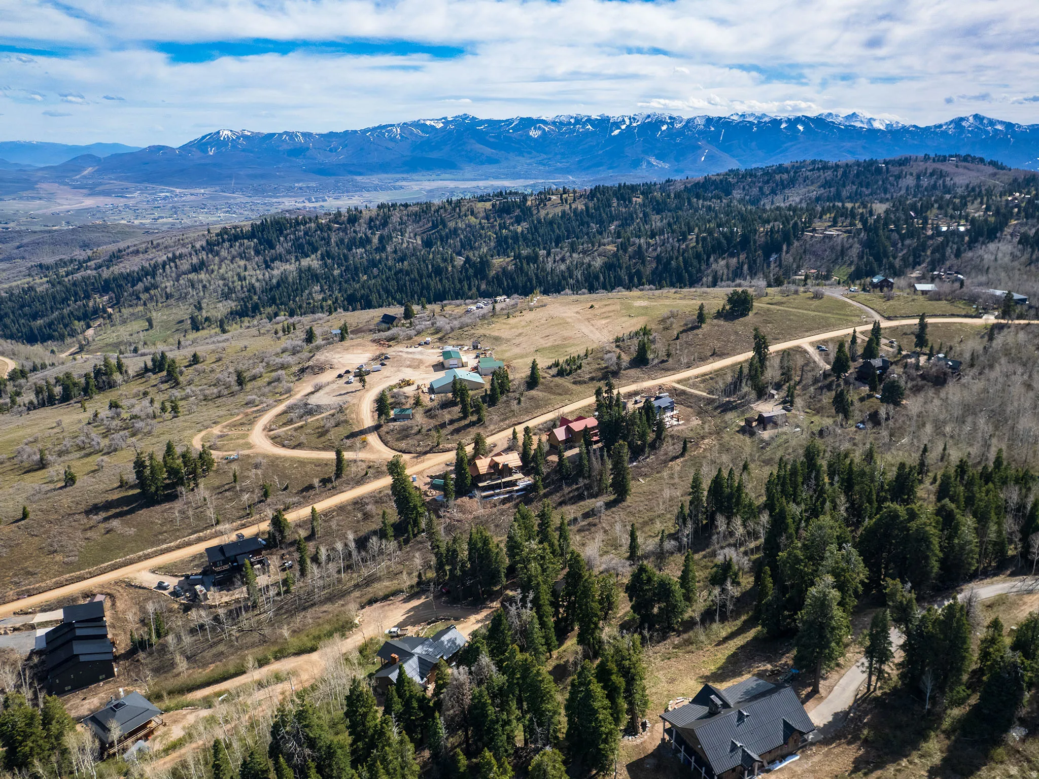 Drone / aerial view of mountains and a heavily wooded area