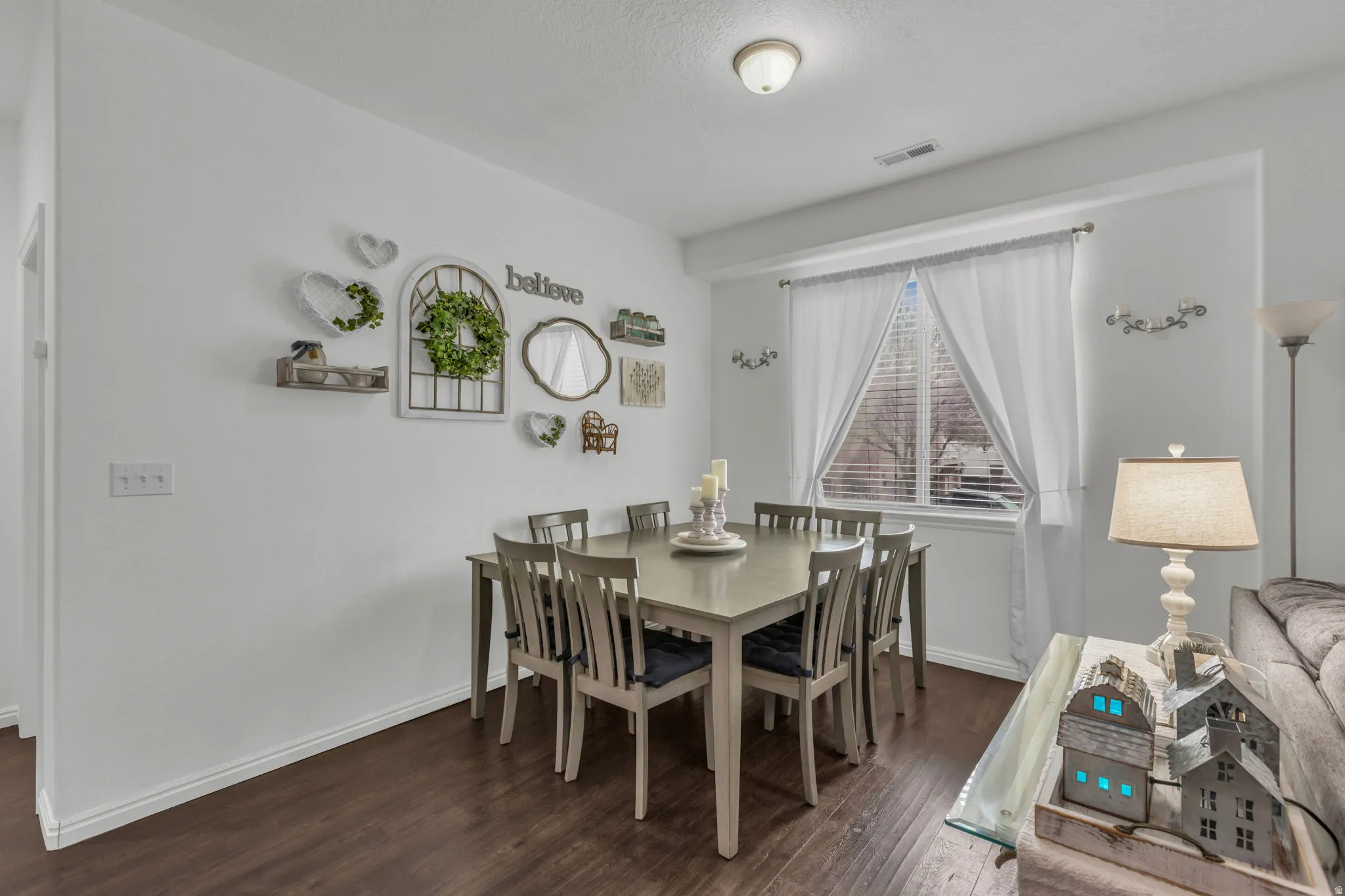 Dining room with dark wood finished floors and baseboards