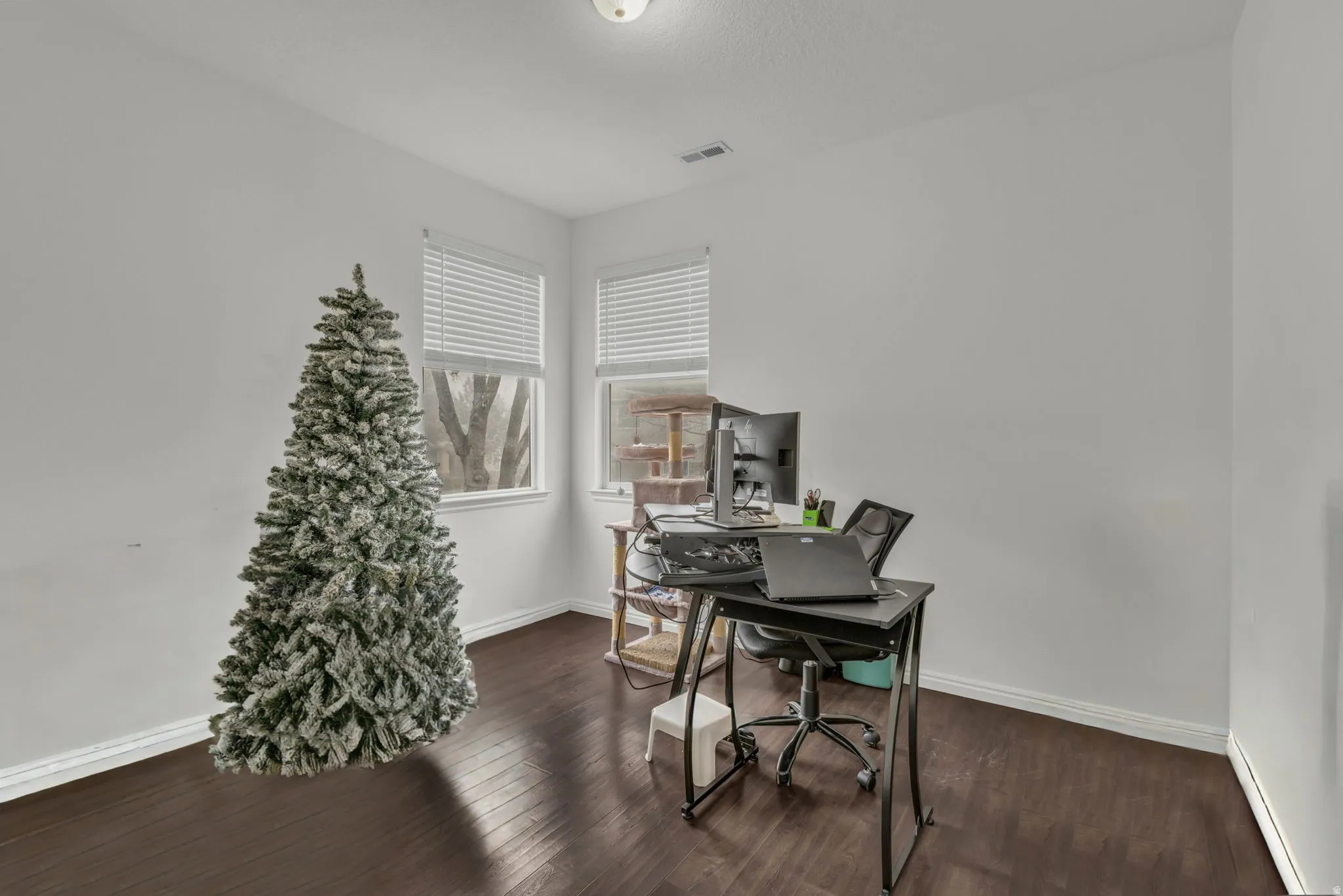 Home office featuring dark wood finished floors and baseboard heating