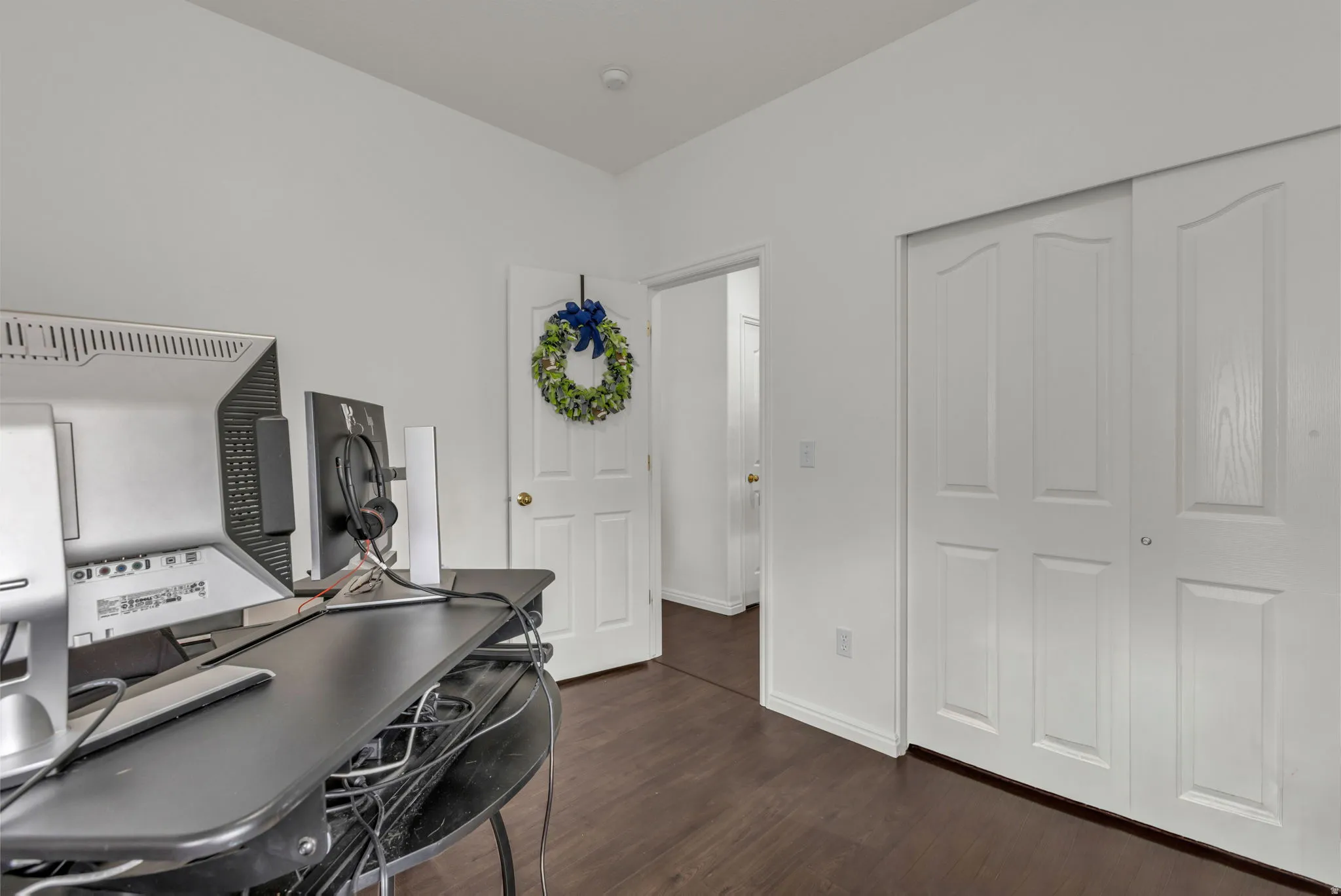 Office area with dark wood finished floors and baseboards
