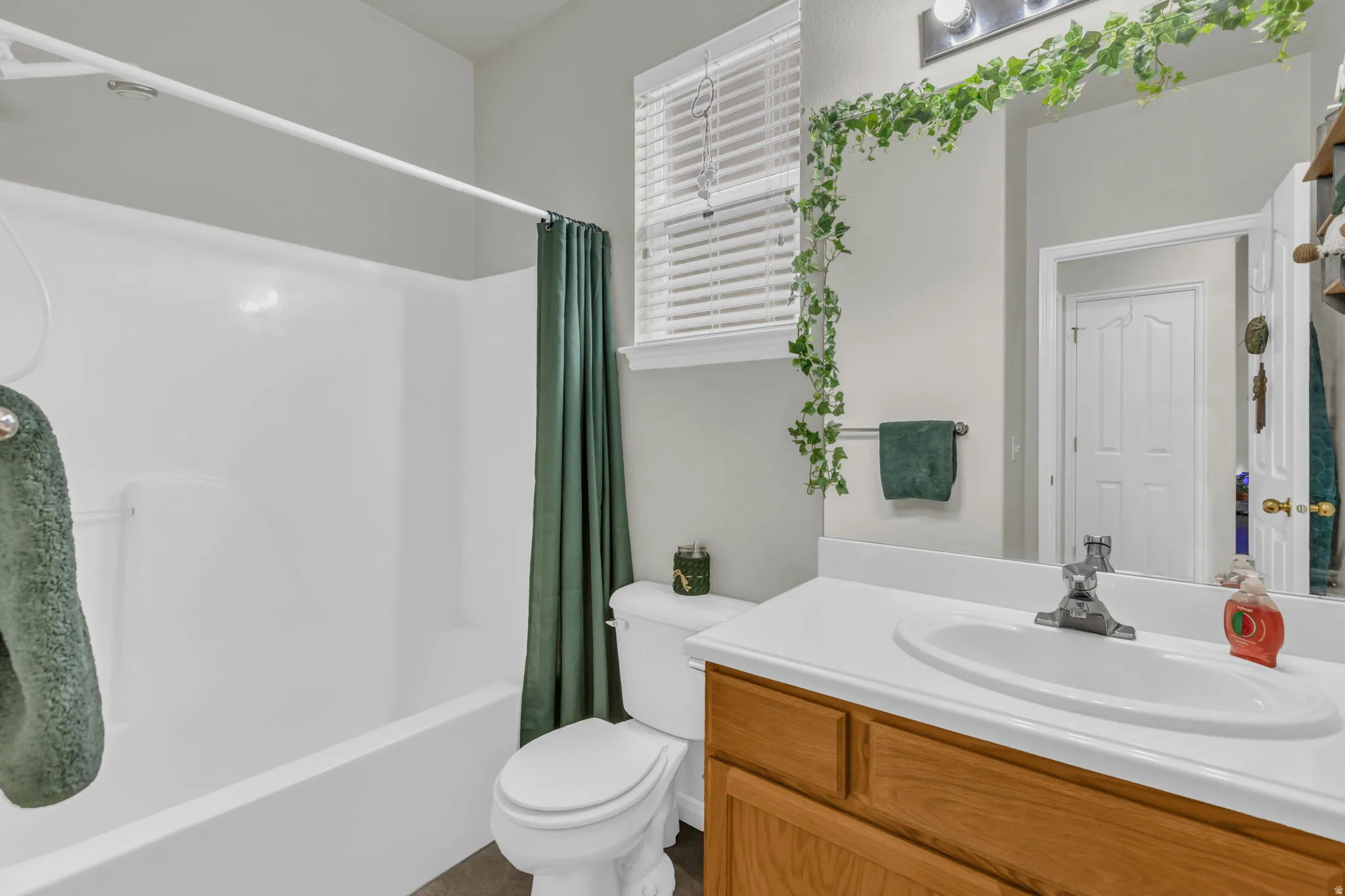Full bathroom with vanity and shower / bathtub combination with curtain