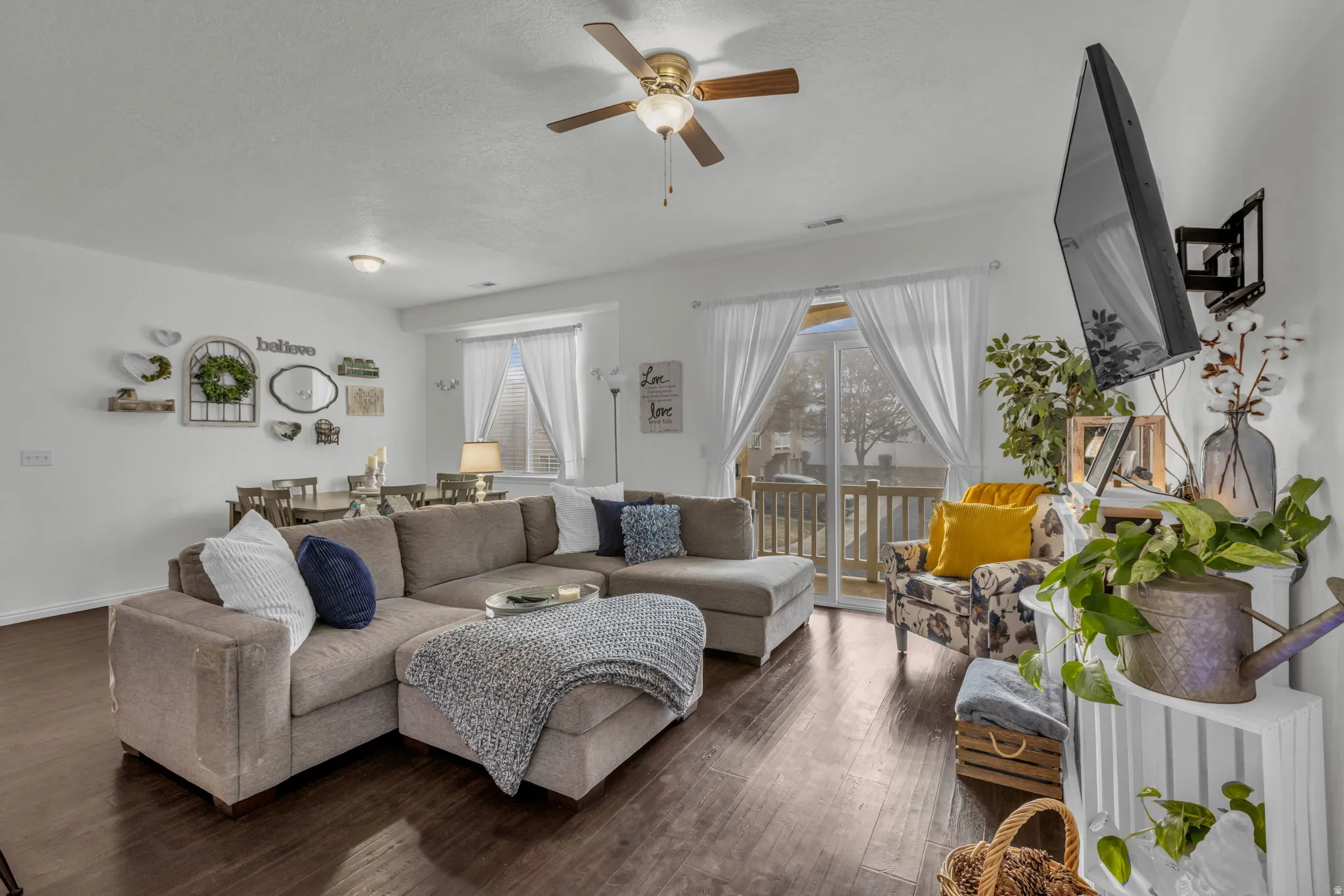 Living area with wood-type flooring and ceiling fan