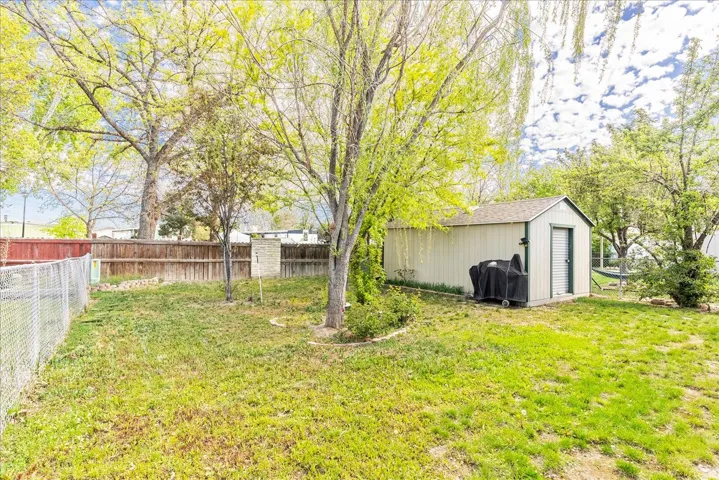 Fenced backyard with a shed