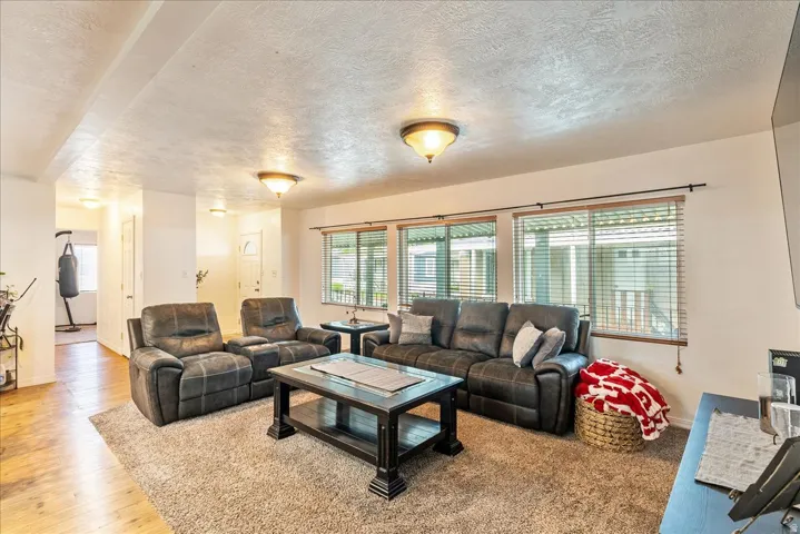 Living room featuring a textured ceiling and wood finished floors