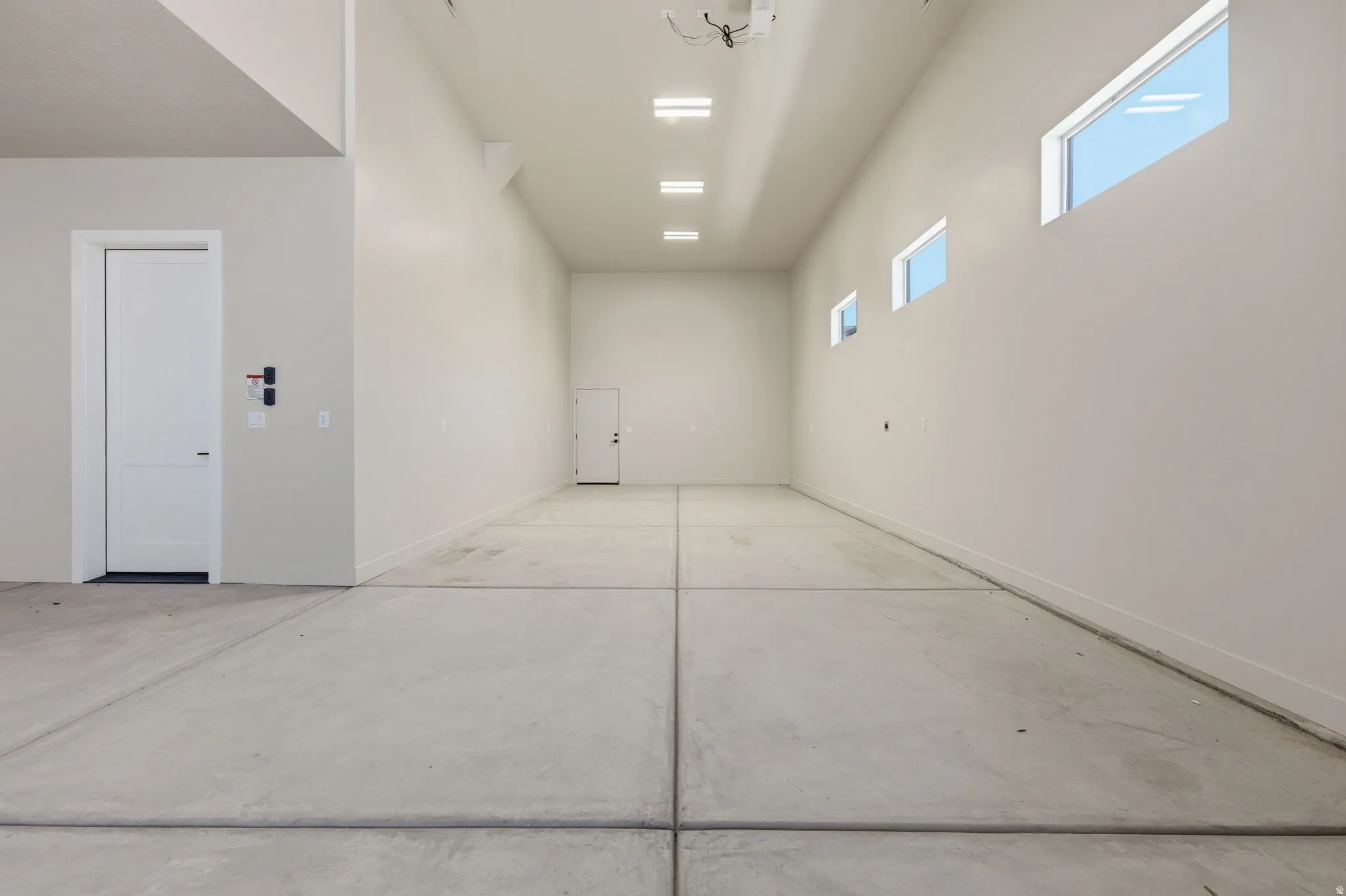 Garage featuring baseboards