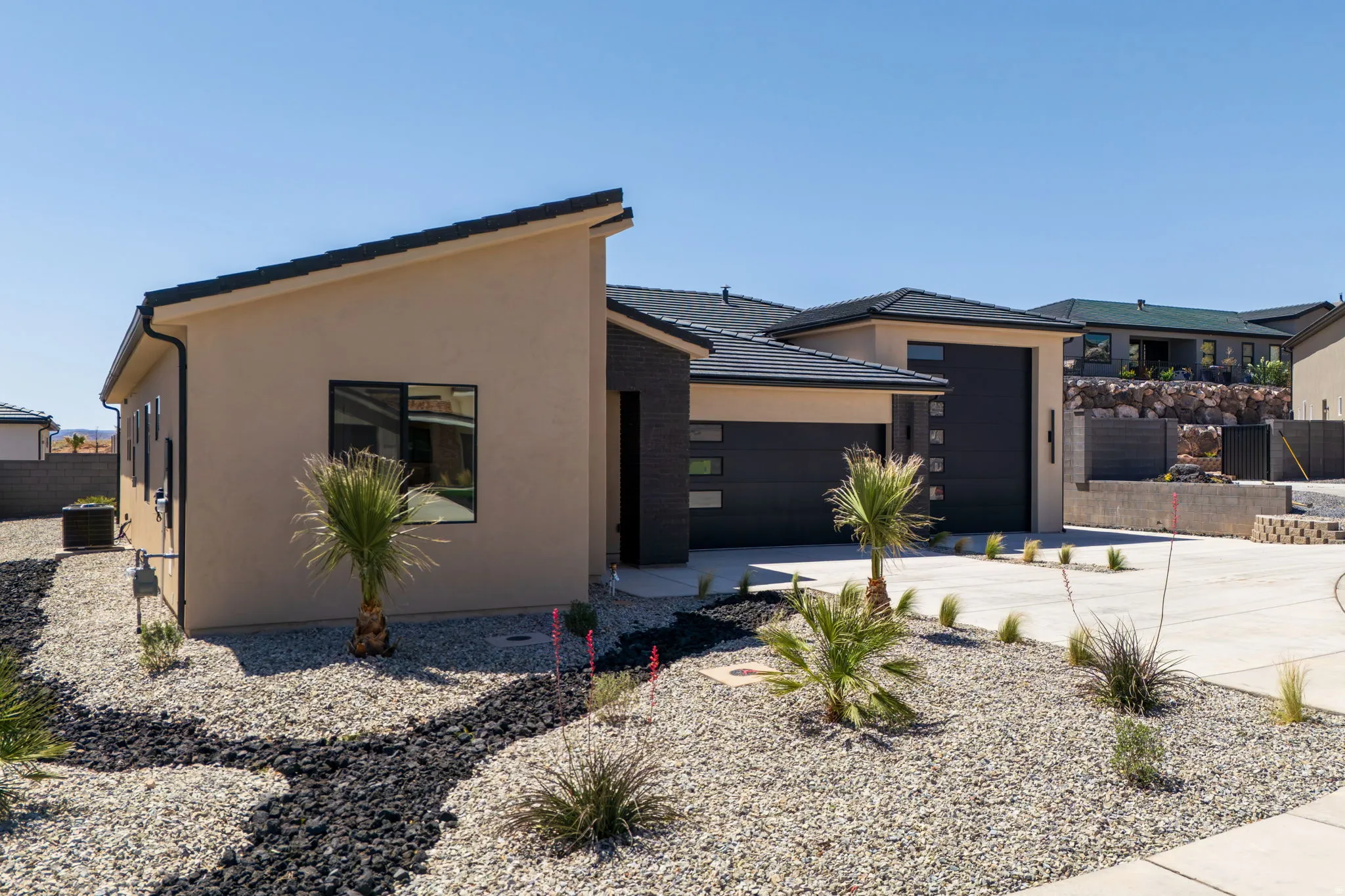 View of front of home featuring stucco siding, driveway, and an attached garage