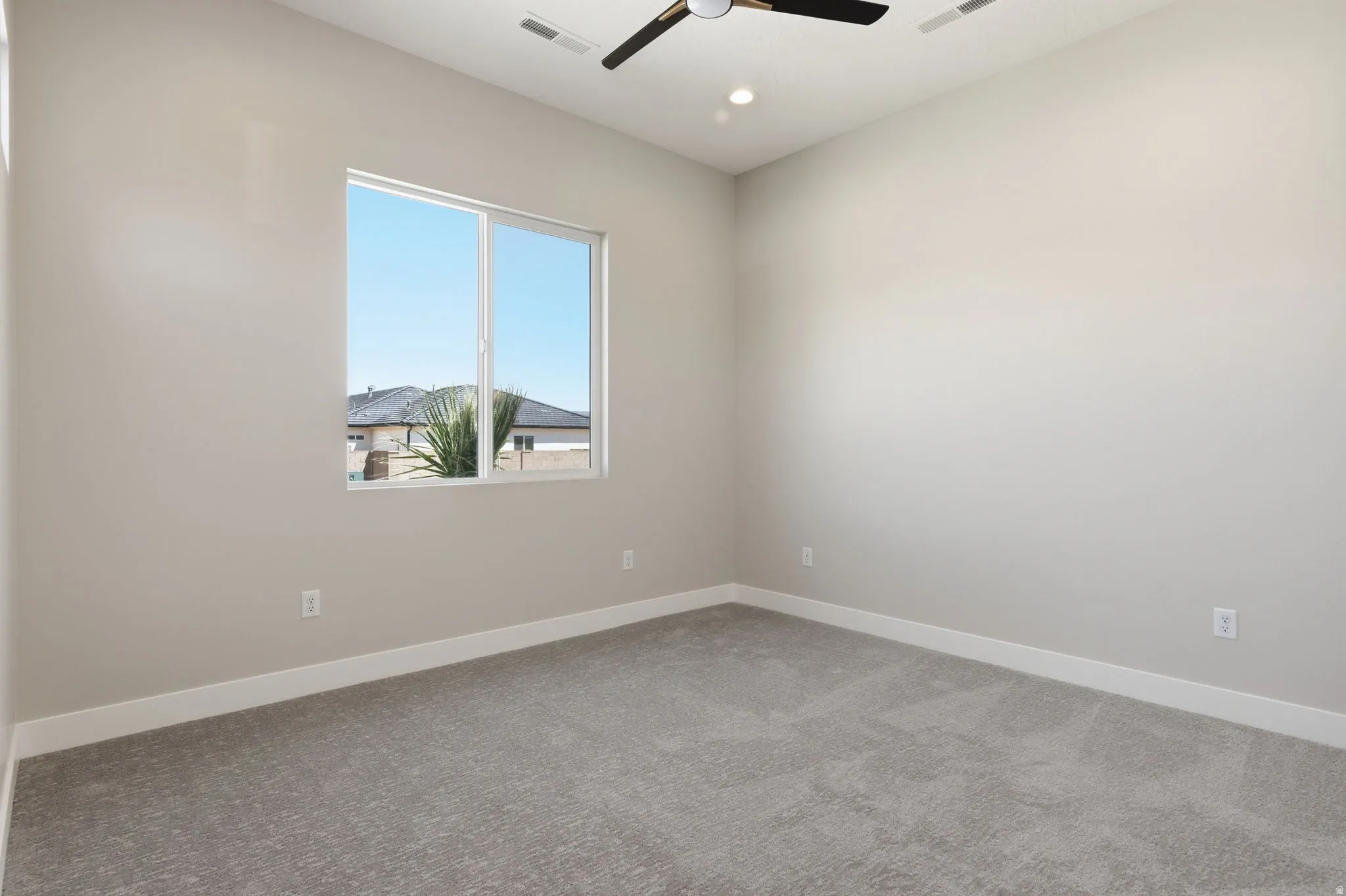 Spare room featuring a ceiling fan, light colored carpet, and recessed lighting