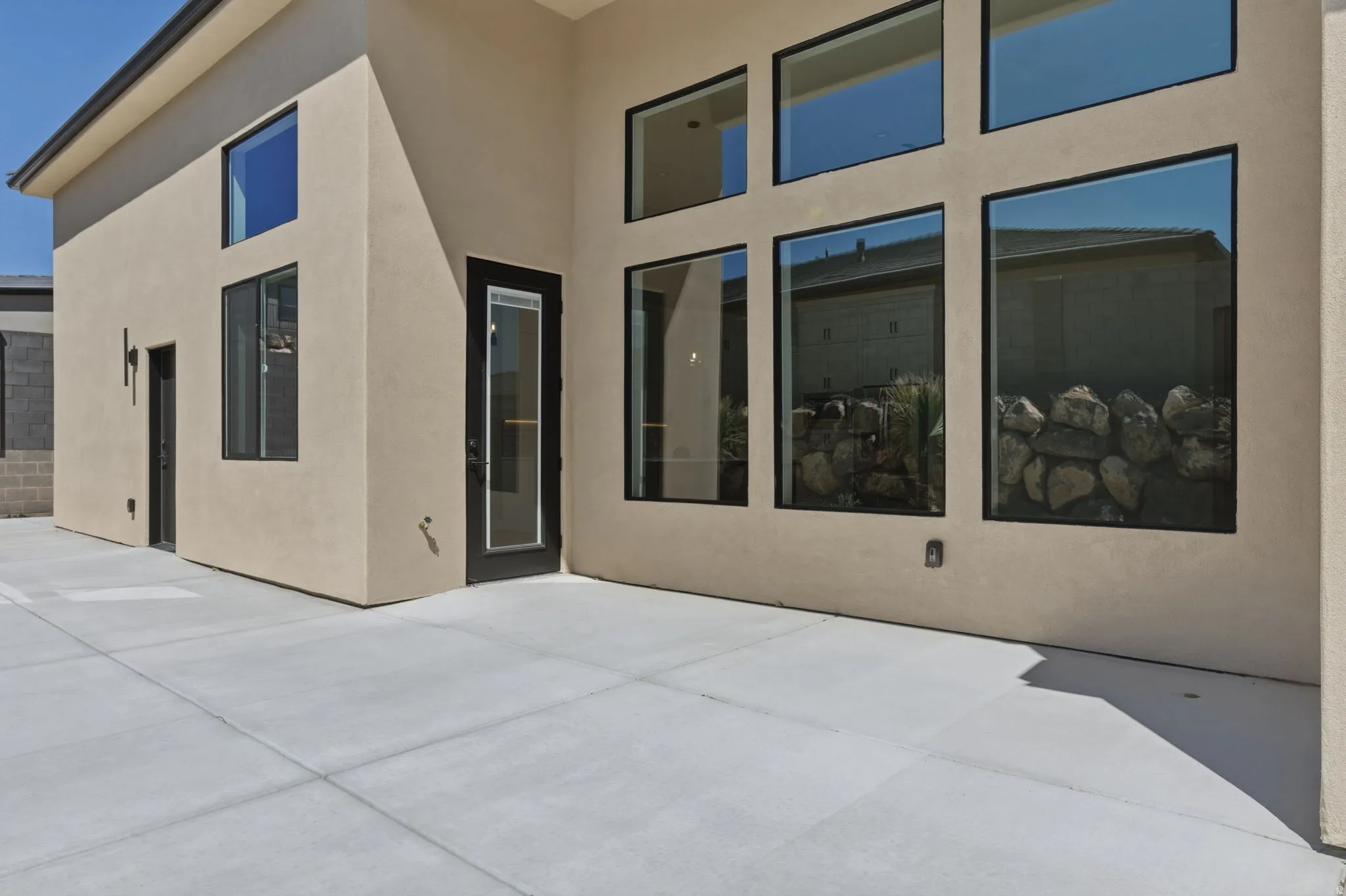 Rear view of house with a patio area and stucco siding