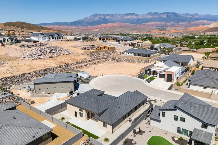 Aerial perspective of suburban area featuring a mountainous background