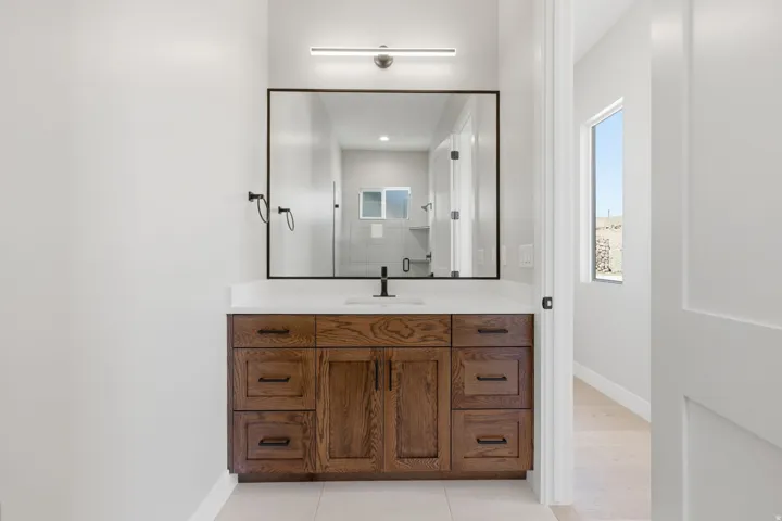 Bathroom with vanity, light tile patterned floors, a shower, and recessed lighting