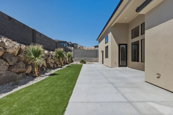Fenced backyard with a patio