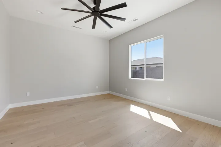 Empty room with light wood-type flooring, ceiling fan, and recessed lighting