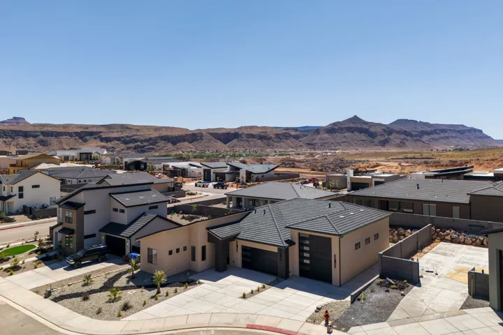 Aerial perspective of suburban area with a mountainous background