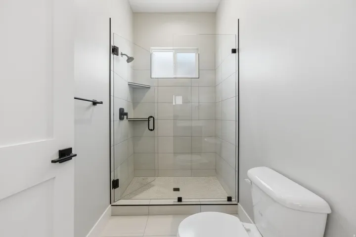 Full bath with a stall shower and light tile patterned floors