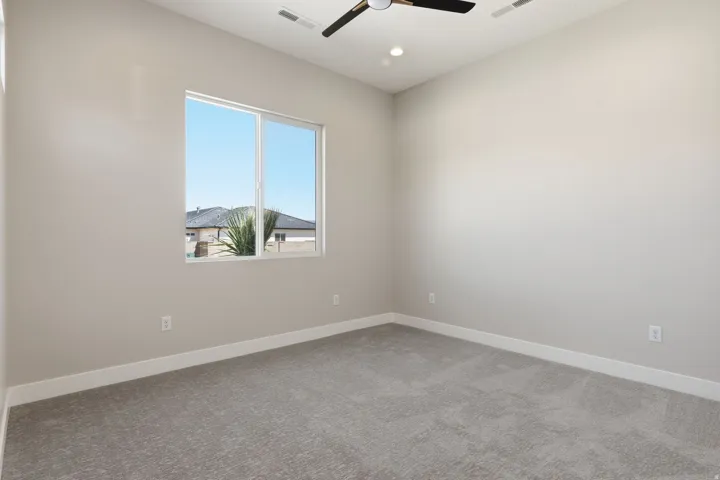 Spare room featuring a ceiling fan, light colored carpet, and recessed lighting