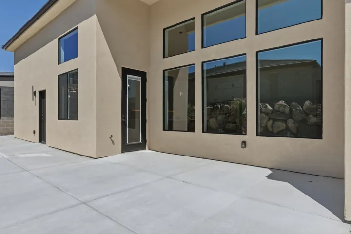 Rear view of house with a patio area and stucco siding