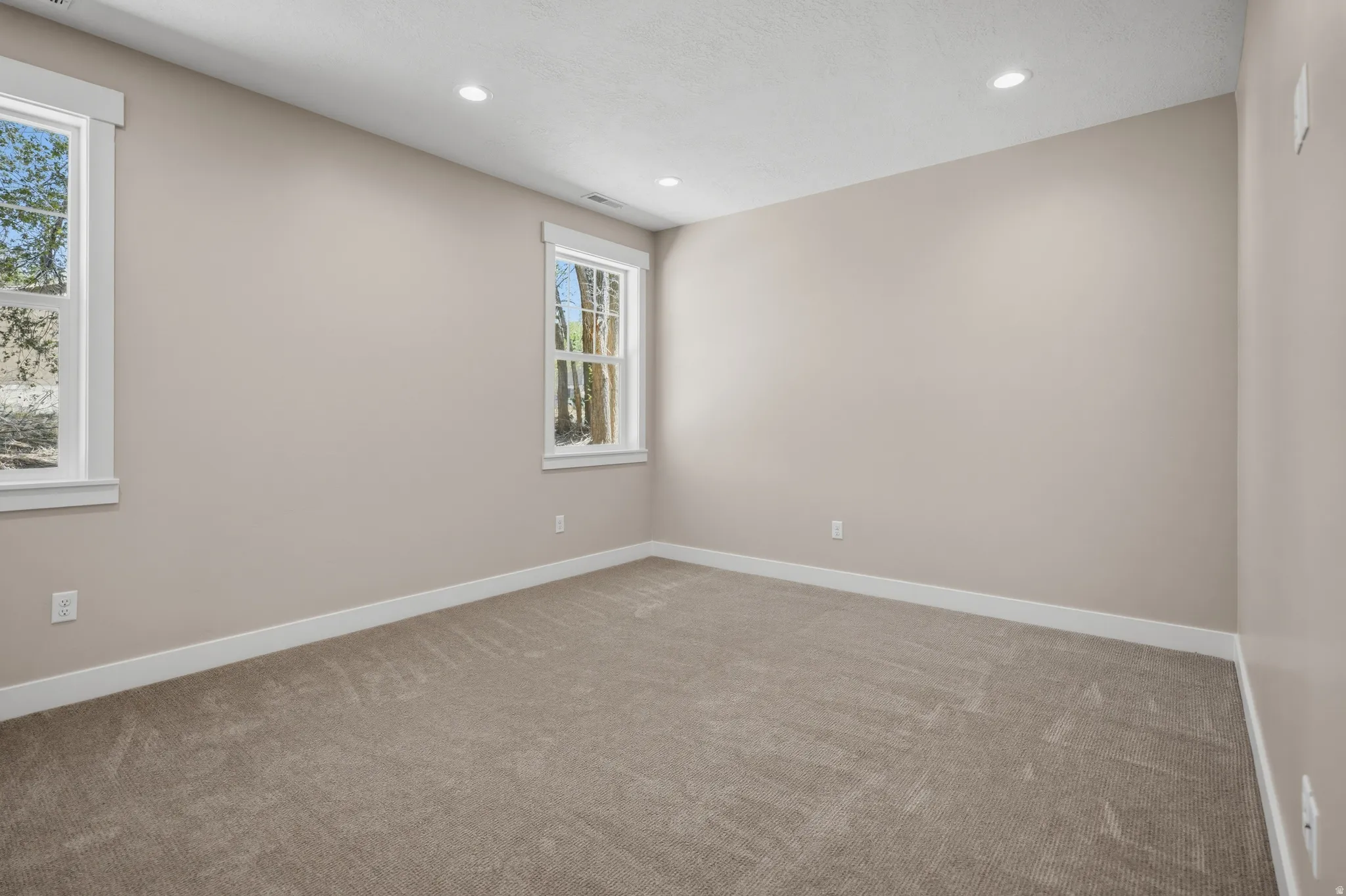 Unfurnished room featuring light carpet and recessed lighting