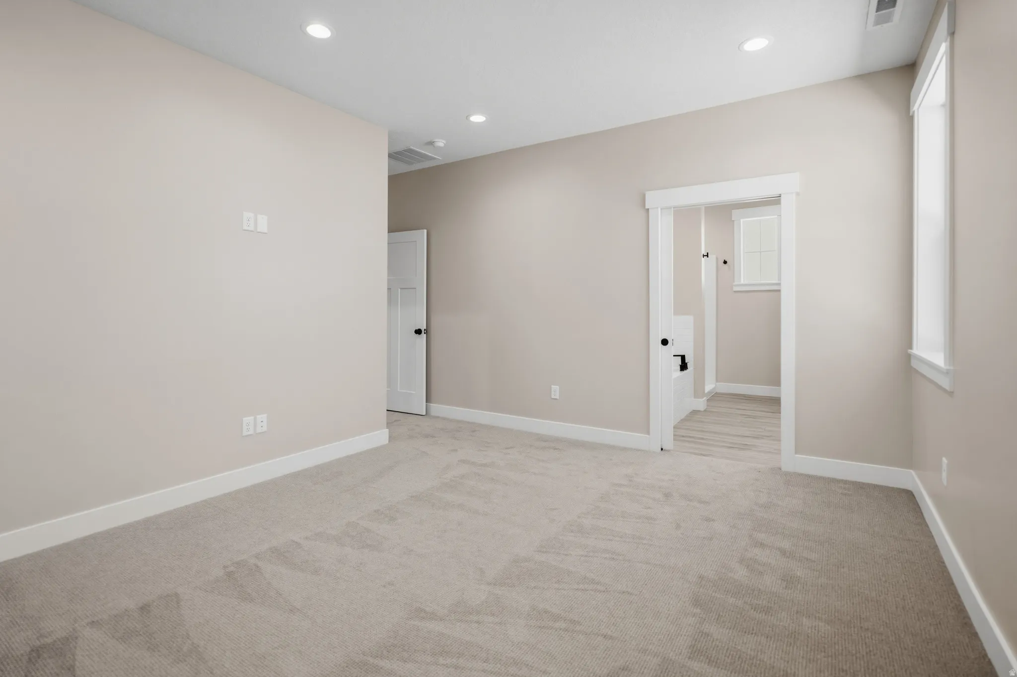 Spare room with recessed lighting and light colored carpet