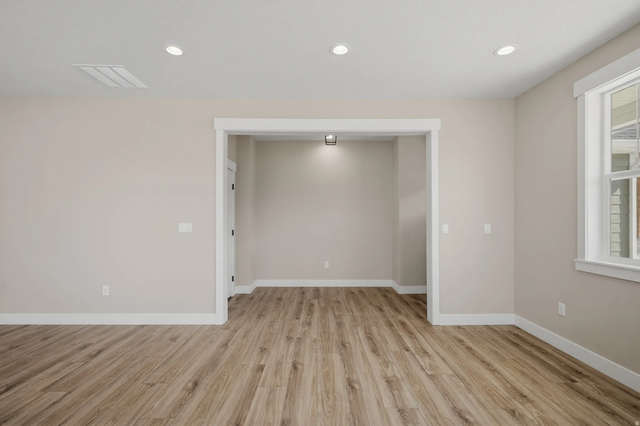 Spare room with light wood-style flooring and recessed lighting
