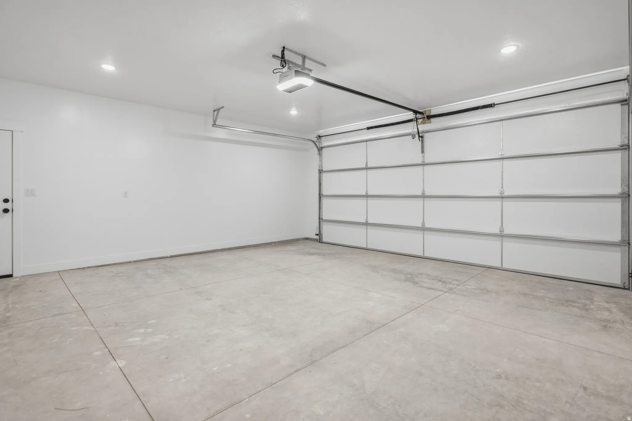Garage with recessed lighting and a garage door opener