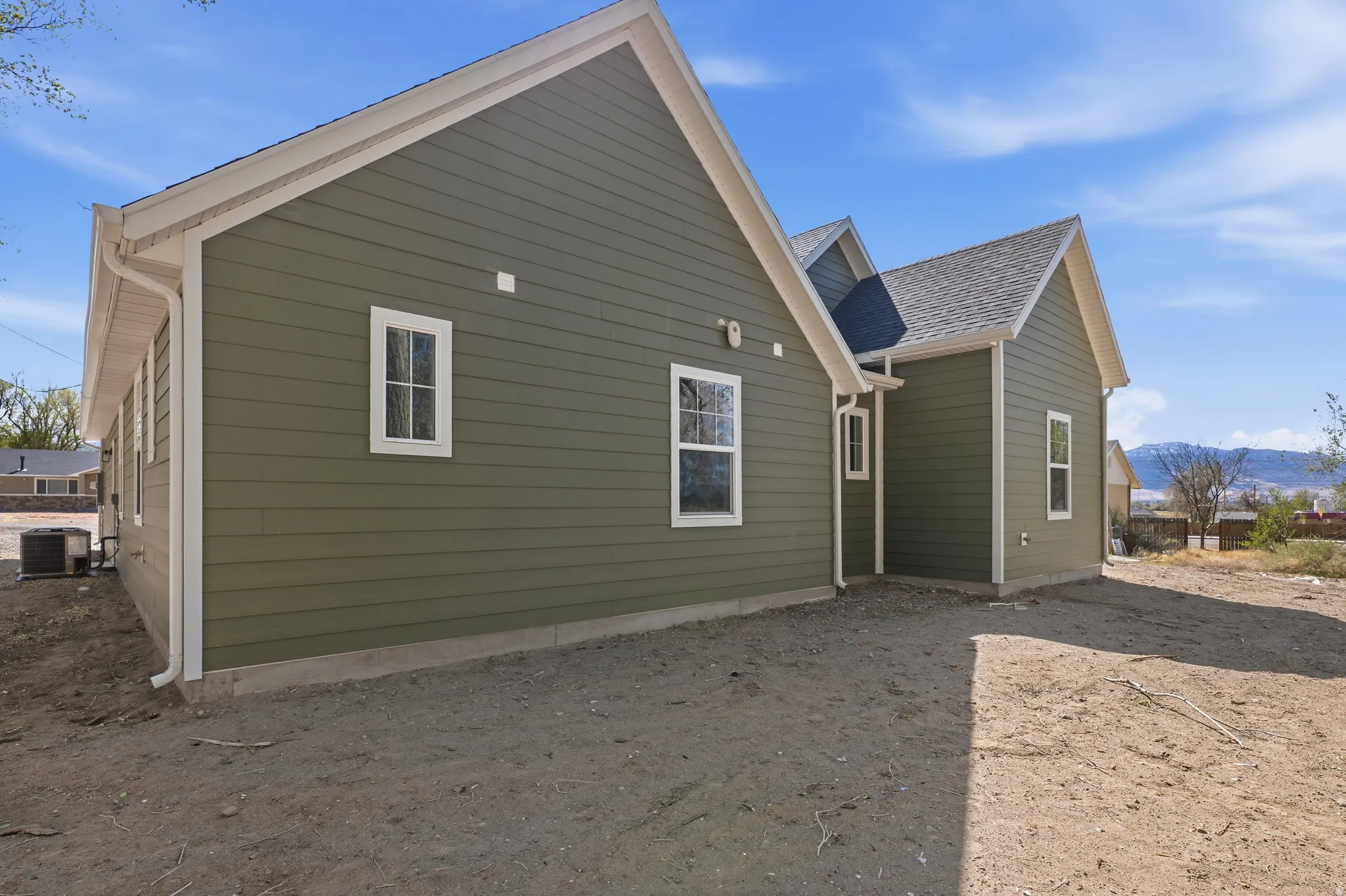 Rear view of property with a mountain view and a shingled roof