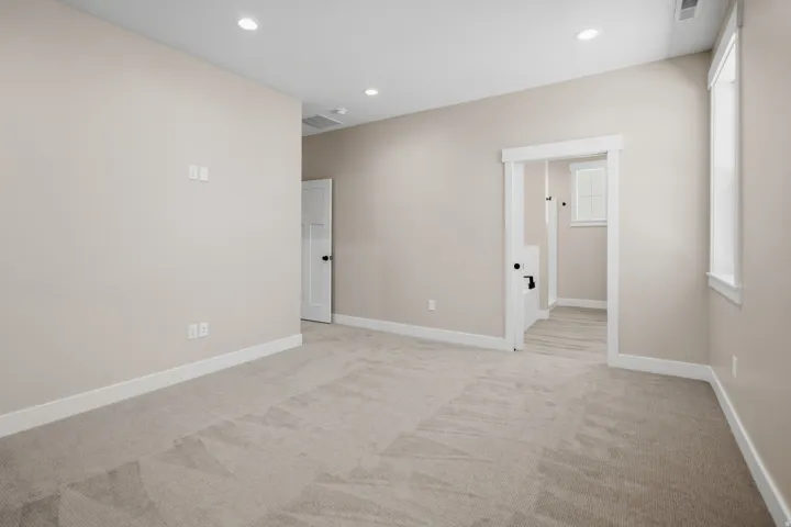 Spare room with recessed lighting and light colored carpet
