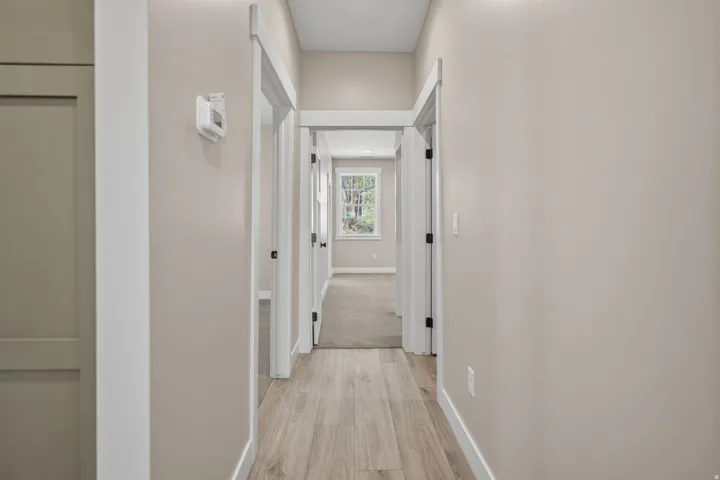 Corridor with baseboards and light wood-type flooring