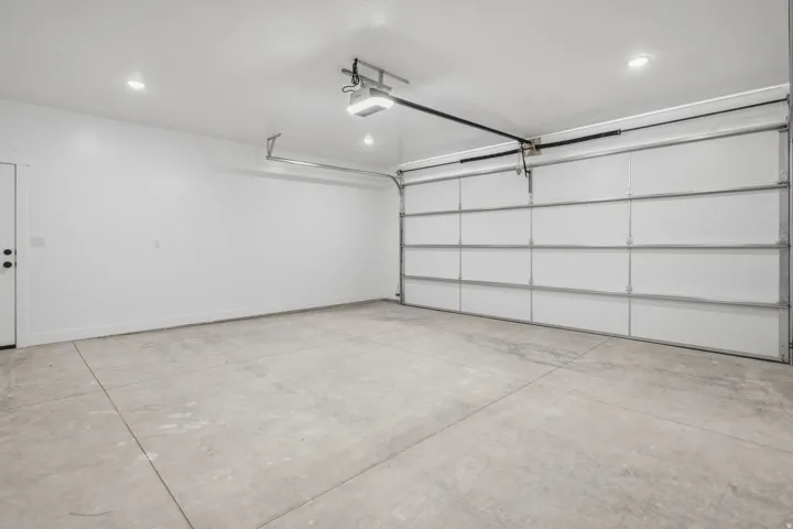 Garage with recessed lighting and a garage door opener