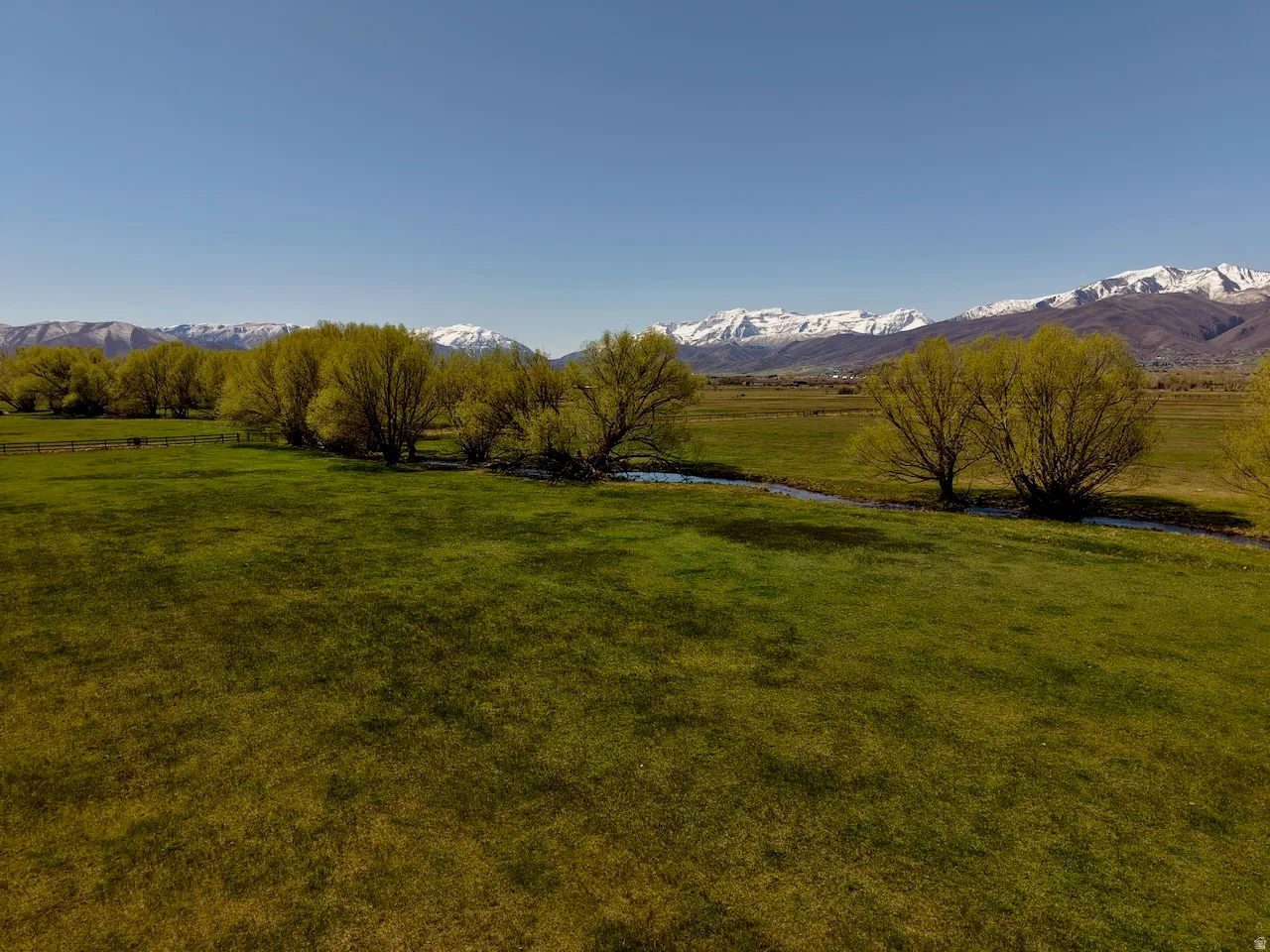 View of green lawn featuring a rural view and a mountain view